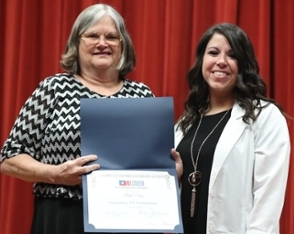 Lori Moseley presenting an Exemplary ATI Performance award to Telisha Diaz of Cleburne.